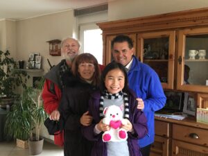 A family posing for the camera in their home.