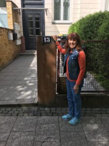 A woman standing in front of a building.