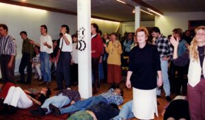 A group of people laying on the ground in front of a crowd.