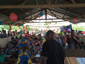 A crowd of people gathered under a roof.