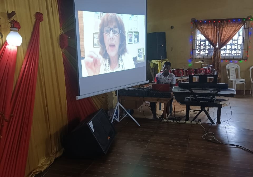 A projector screen with a woman on it