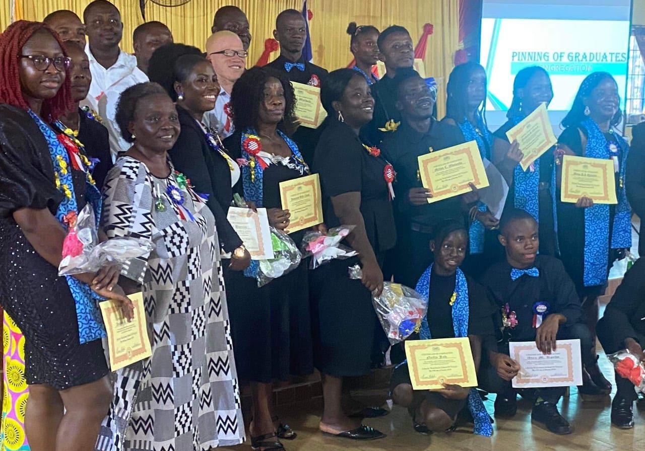 A group of people holding certificates and posing for the camera.