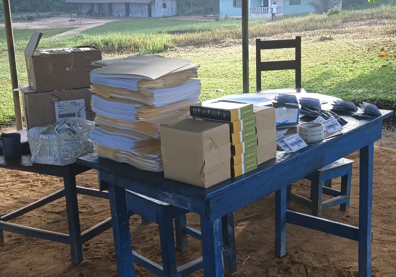 A table with many boxes and chairs on it