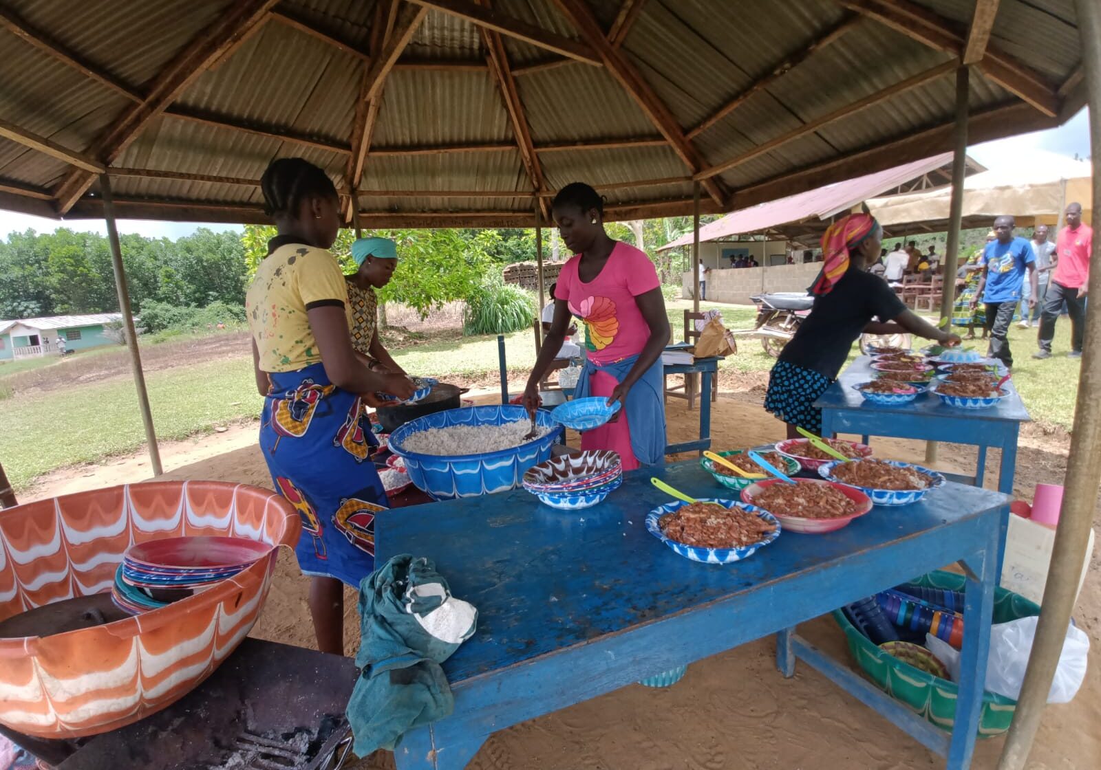 A group of people standing around a table.